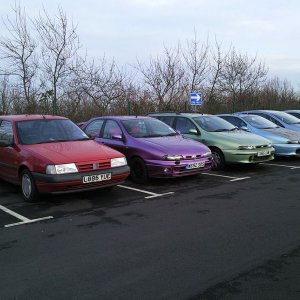 The randomly coloured cars bringing up the rear